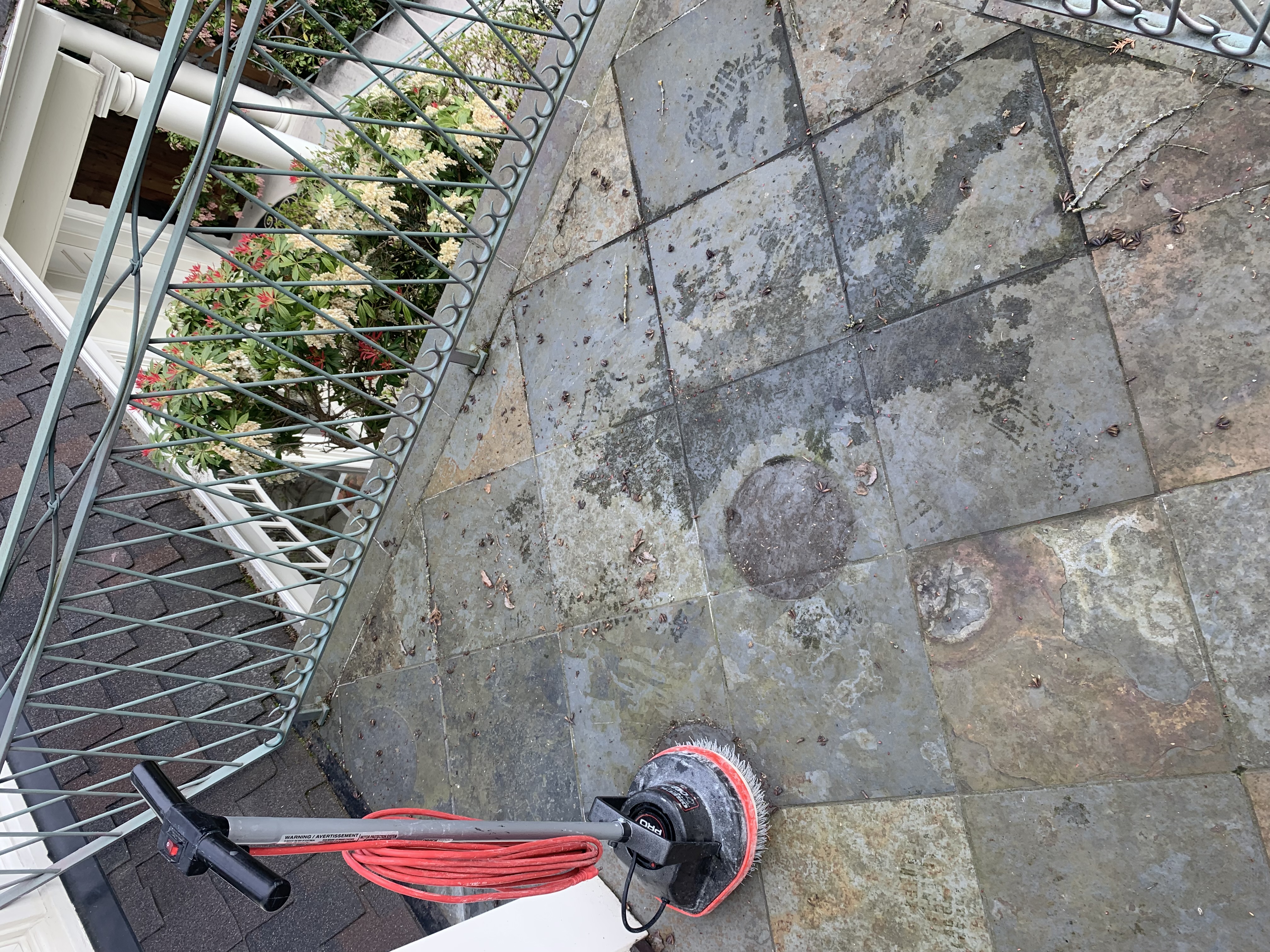 Outdoor patio before cleaning - heavily stained and weathered tiles in Bellevue home